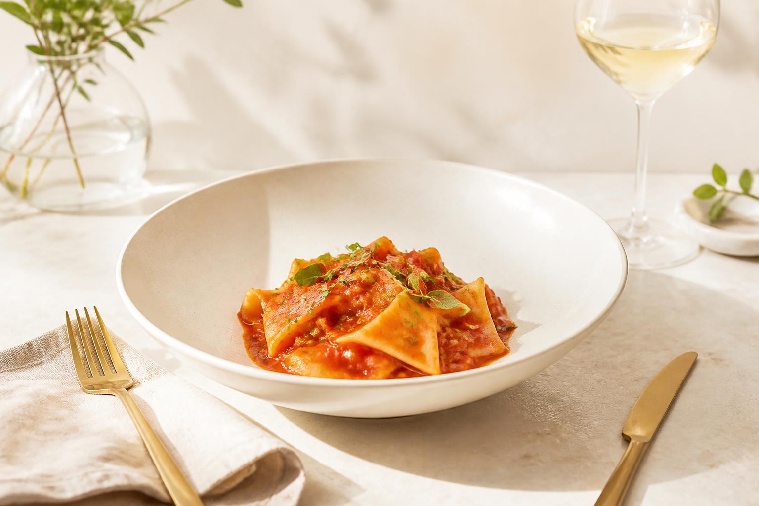 A plated pasta course finished with Table No.9 marinara